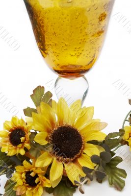 Big yellow wineglass with bouquet of sunflowers