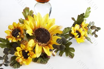 Big yellow wineglass with bouquet of sunflowers