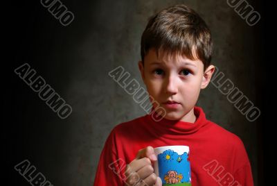 boy drinking tea from cup