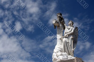 angel statue and cross