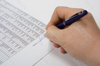 Hand signing the document.