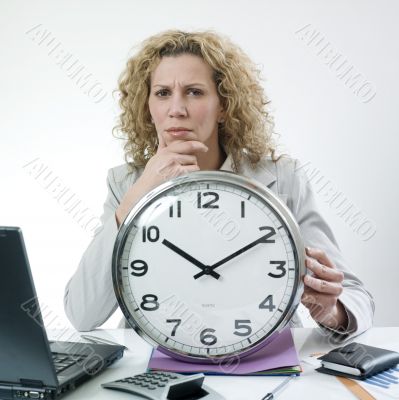 Woman pondering with clock