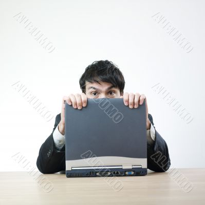 Man afraid behind computer