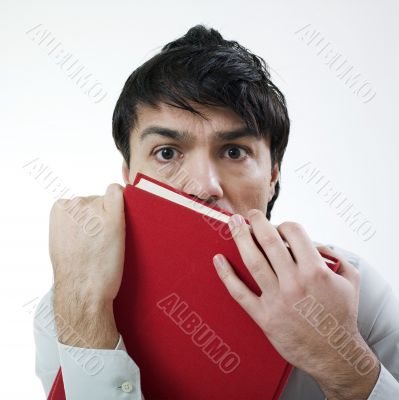 Surprised man with red book