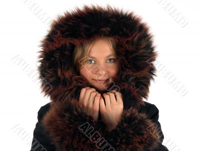 Smiling winter girl with a fur hood
