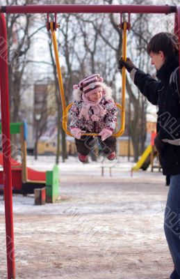 young father swing daughter