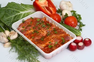 Crude meat with fresh vegetables, greens and seasoning