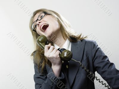 Woman laughing at telephone