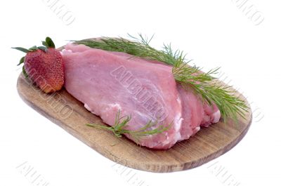 Raw pork schnitzel with dill and a strawberry