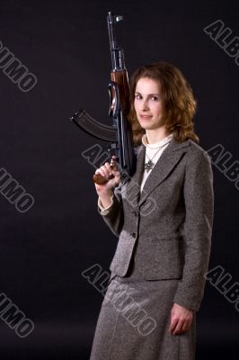 smiling businesswoman wtith submachine gun