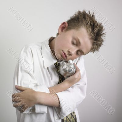 Boy huging piggy bank