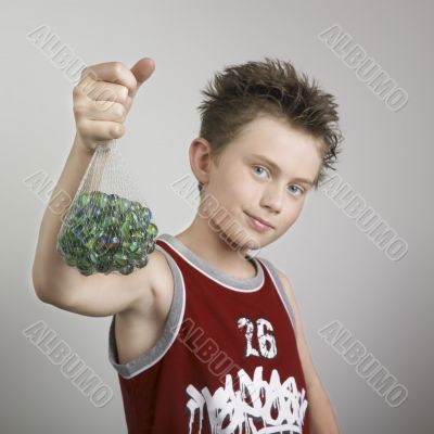 Boy showing marbles