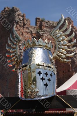 Knightly helmet and ruins of a fortress