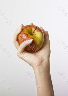 Hand gripping apple