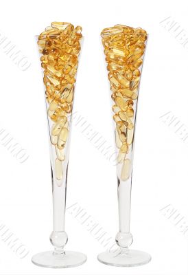 Two glasses with gold boluses Two glasses with gold boluses