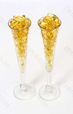Two glasses with gold boluses Two glasses with gold boluses