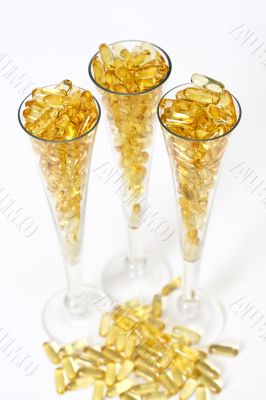 Three glasses with gold boluses Three glasses with gold boluses