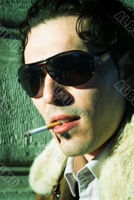 Sexy young man smoking cigarette