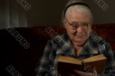 Wise woman behind reading by the book