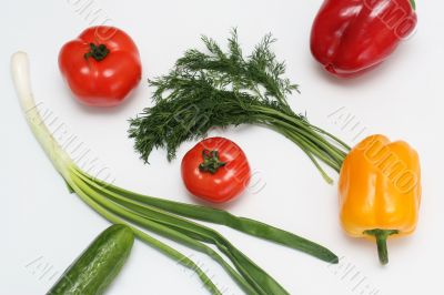 Multi-coloured vegetables for salad on a white background