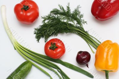 Multi-coloured vegetables for salad on a white background