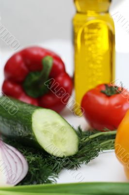 Multi-coloured vegetables for salad on a white background