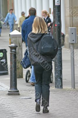 Blonde Woman Shopping with Backpack