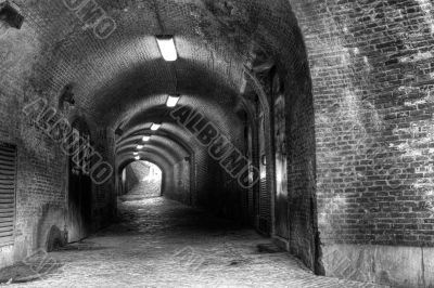 Gloomy medieval brick tunnel