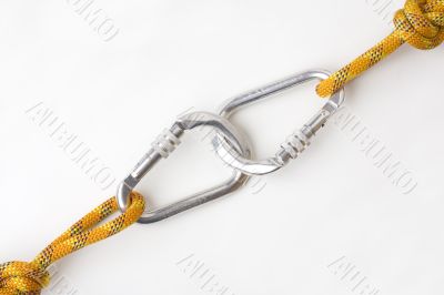 Two connected carabiners, each on knotted rope
