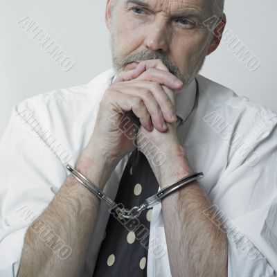 Thinking man with cuffs