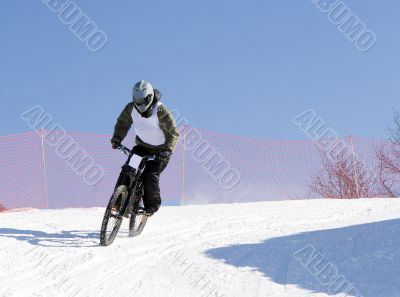 Professional winter biker in mountains at contest