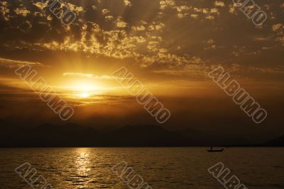 sunset on the sea side with silhouettes