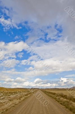 Lonely road under cloudy sky