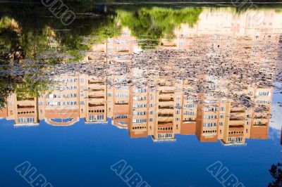 Blue sky and rose build, reflection in deep pond Blue sky and rose build, reflection in deep pond