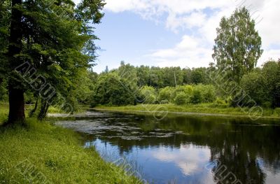 Blue reflection in river  at summer forest, Russia