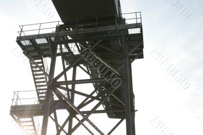 Sunshine Through Steps of Industrial Conveyor