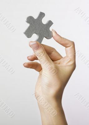 Hand holding puzzle piece Hand holding puzzle piece