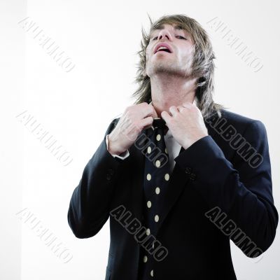 Man in suit adjusting tie