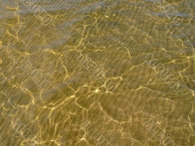 transparent water, waved sand