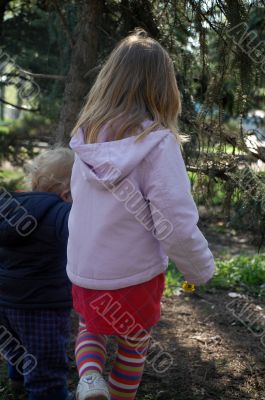 two small kids taking a walk