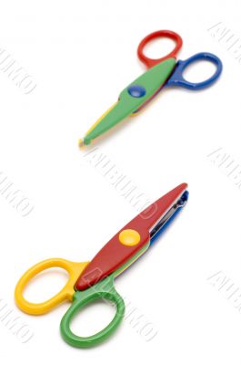 Colored scissors on white