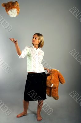 Young woman playing with the teddy bear