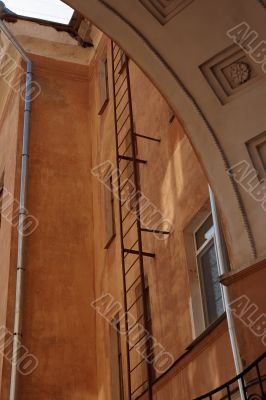 Yellow wall behind an arch.