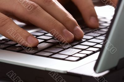 fingers on the laptop keyboard