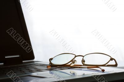 laptop with laying glasses