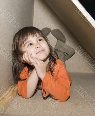 Child girl hiding in wooden box, dreams alone