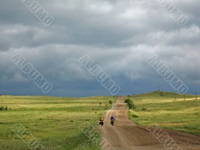 Couple of cyclists go to road. Bike Touring.