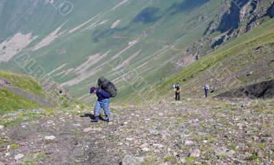 Three people making their descent up