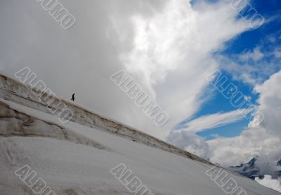 Climber making their descent down a snowy slope