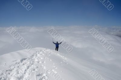 Climber standing on top of mountain